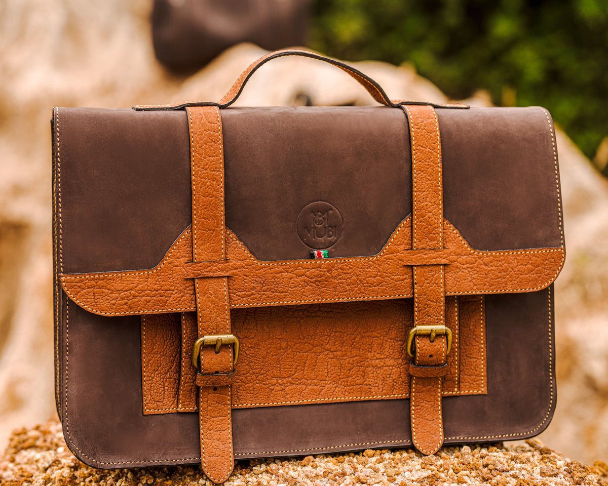 Mubi Leather satchel resting on rock, Timeless African Craftsmanship hero